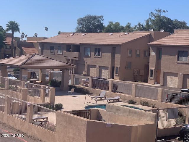 view of property's community with a gazebo, a patio, and fence