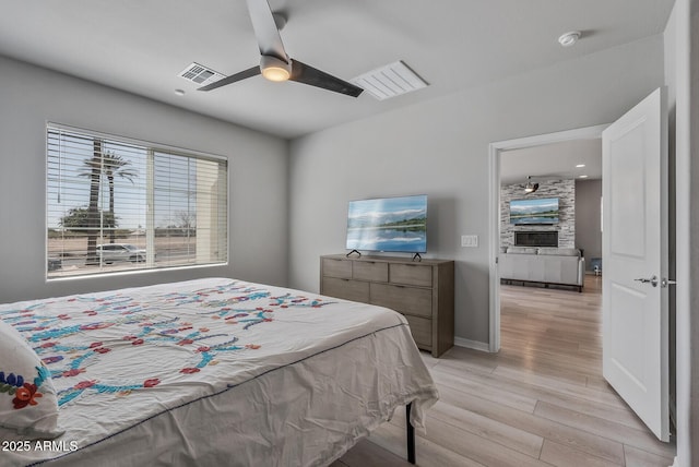 bedroom with baseboards, ceiling fan, and light wood finished floors