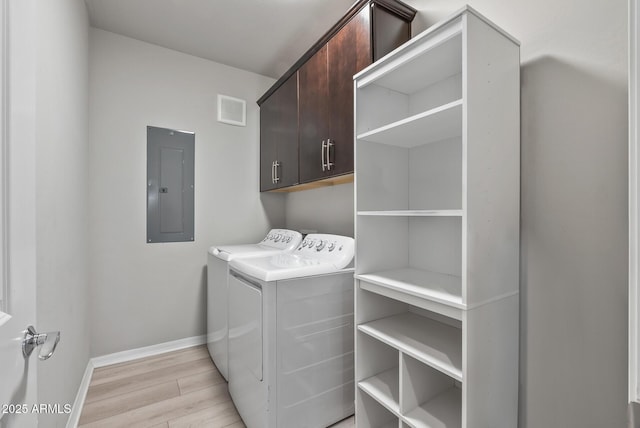 washroom featuring cabinet space, visible vents, light wood-style flooring, electric panel, and independent washer and dryer