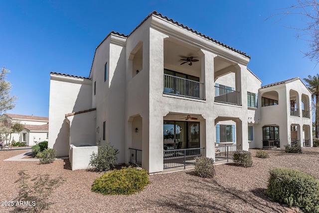 back of house featuring a tile roof, ceiling fan, a patio, and stucco siding