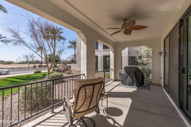 view of patio with area for grilling, a balcony, and a ceiling fan