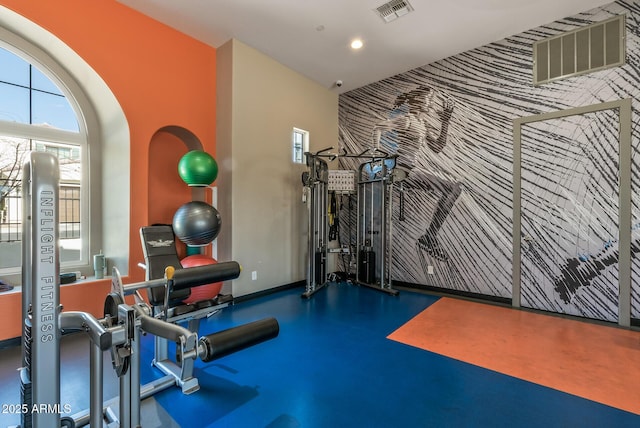 workout room with baseboards, an accent wall, visible vents, and recessed lighting