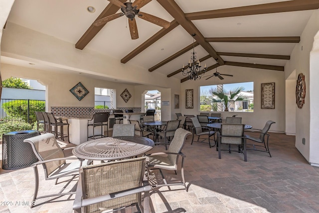 view of patio featuring fence, outdoor dry bar, outdoor dining area, and a ceiling fan