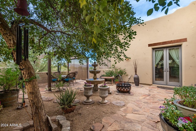 view of patio / terrace with french doors and a fire pit