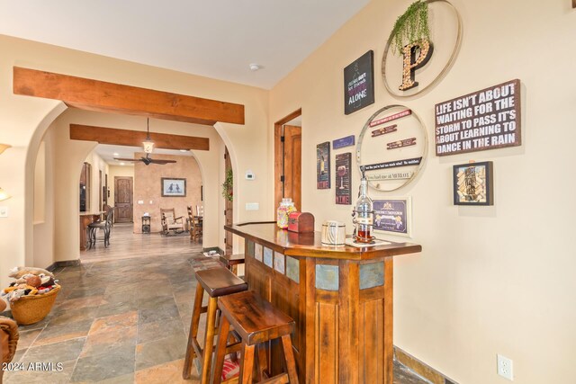 kitchen featuring ceiling fan, sink, black appliances, pendant lighting, and a kitchen island