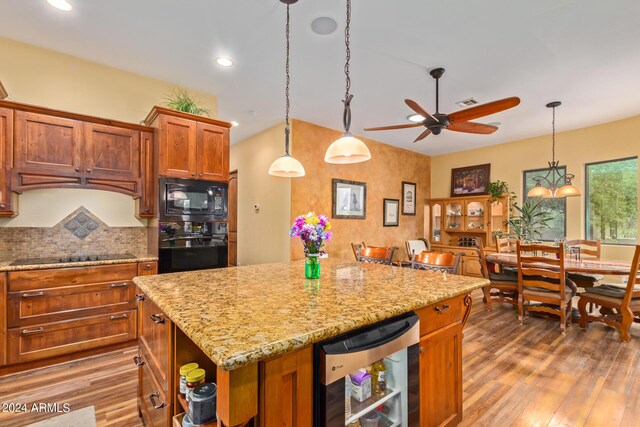 dining space with ceiling fan and hardwood / wood-style flooring