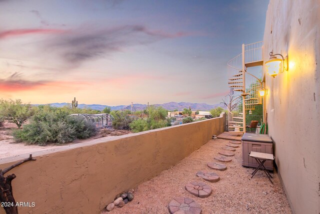 view of patio featuring ceiling fan and a mountain view