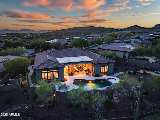 42429 N Cross Timbers Ct, Anthem, AZ 85086 - rear view of house with a tiled roof, a fenced backyard, a mountain view, and a pool with connected hot tub