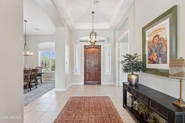 42429 N Cross Timbers Ct, Anthem, AZ 85086 - foyer featuring a chandelier, light tile patterned floors, a tray ceiling, and baseboards