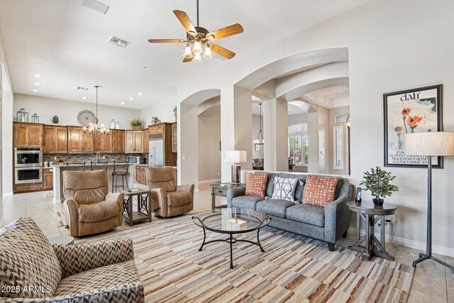 42429 N Cross Timbers Ct, Anthem, AZ 85086 - living area featuring light tile patterned floors, a ceiling fan, arched walkways, recessed lighting, and a chandelier
