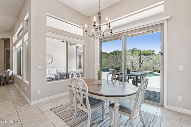 42429 N Cross Timbers Ct, Anthem, AZ 85086 - dining area with light tile patterned floors, a chandelier, arched walkways, and baseboards