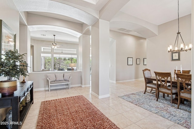 42429 N Cross Timbers Ct, Anthem, AZ 85086 - dining area with arched walkways, ceiling fan, light tile patterned floors, and a chandelier