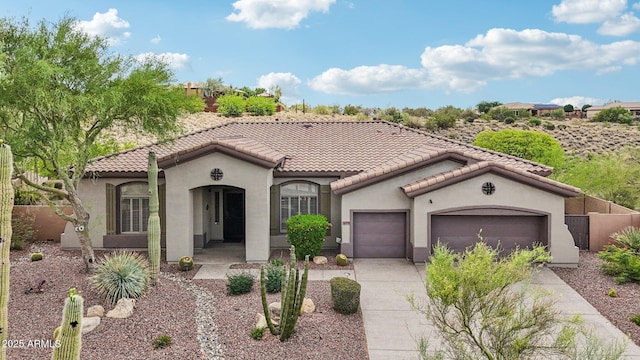 42429 N Cross Timbers Ct, Anthem, AZ 85086 - mediterranean / spanish-style home featuring an attached garage, driveway, stucco siding, and a tiled roof