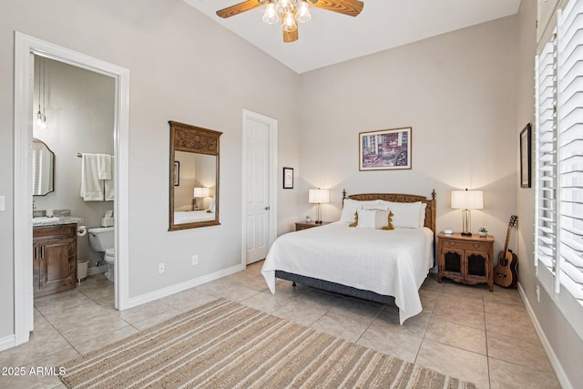 42429 N Cross Timbers Ct, Anthem, AZ 85086 - bedroom with light tile patterned flooring, baseboards, ensuite bath, and ceiling fan
