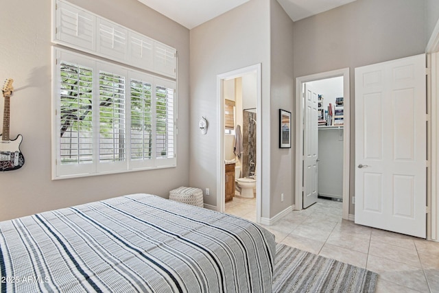 42429 N Cross Timbers Ct, Anthem, AZ 85086 - bedroom featuring light tile patterned floors, a spacious closet, connected bathroom, a closet, and baseboards