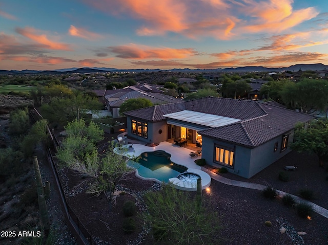 42429 N Cross Timbers Ct, Anthem, AZ 85086 - back of house featuring stucco siding, a fenced backyard, a patio, a mountain view, and an outdoor pool