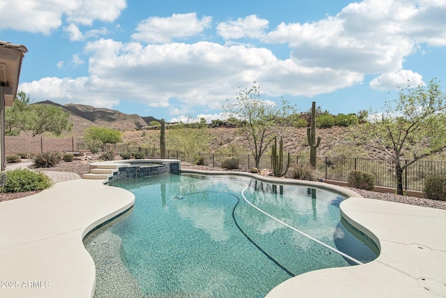 42429 N Cross Timbers Ct, Anthem, AZ 85086 - view of swimming pool featuring a fenced backyard, a pool with connected hot tub, and a mountain view