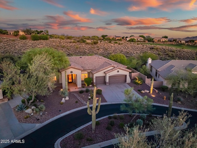 42429 N Cross Timbers Ct, Anthem, AZ 85086 - mediterranean / spanish house with concrete driveway, an attached garage, a tiled roof, and stucco siding