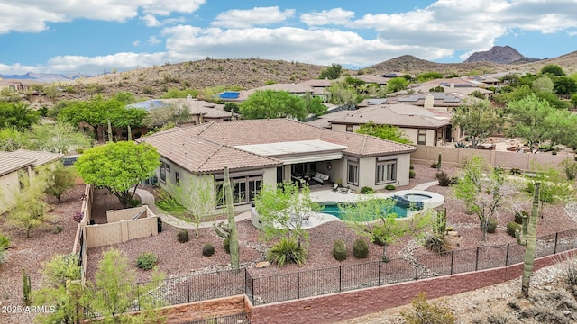 42429 N Cross Timbers Ct, Anthem, AZ 85086 - back of property with stucco siding, a patio area, and a mountain view