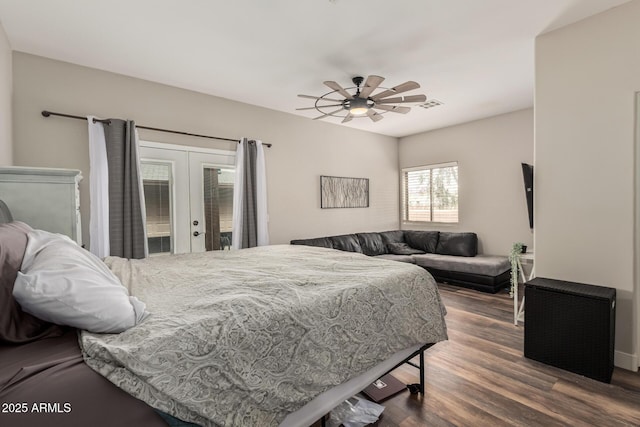 bedroom featuring dark wood-style floors, visible vents, ceiling fan, french doors, and access to outside