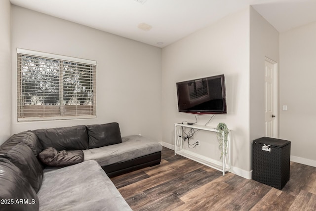 living area with wood finished floors and baseboards