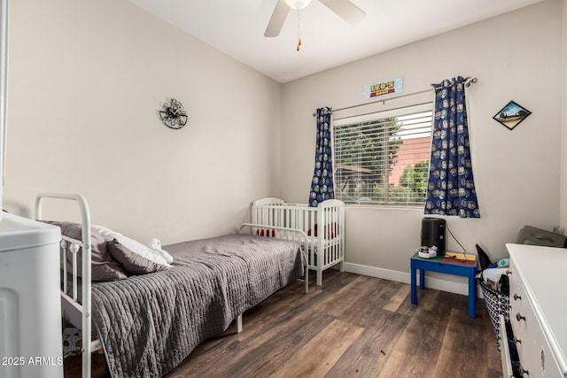 bedroom featuring ceiling fan, baseboards, and wood finished floors