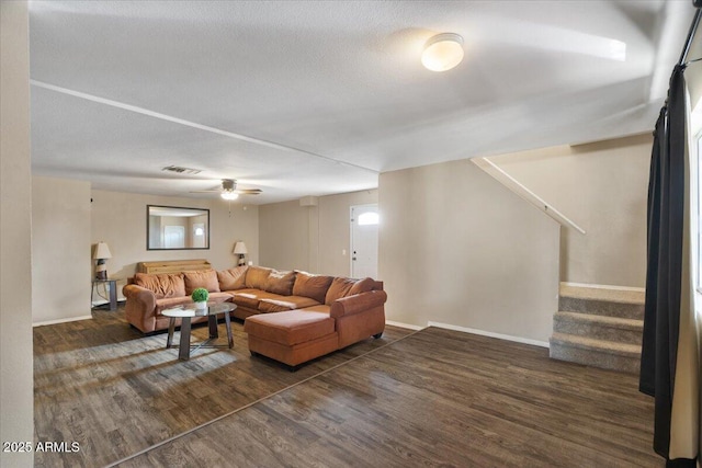 living room with dark wood-type flooring and a textured ceiling