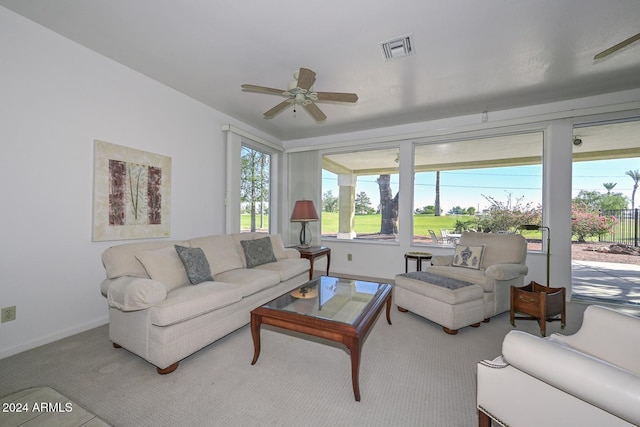 carpeted living room with ceiling fan