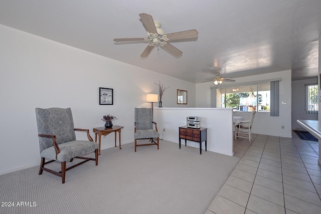 sitting room featuring light tile patterned floors and ceiling fan