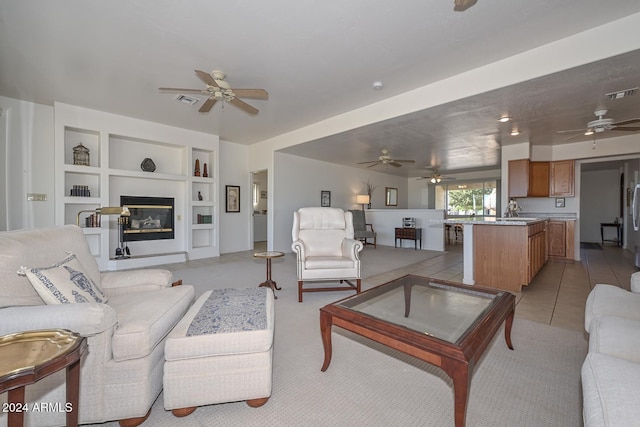 tiled living room featuring built in shelves