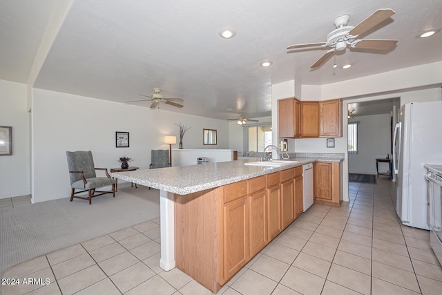 kitchen featuring white appliances, sink, a kitchen breakfast bar, kitchen peninsula, and light colored carpet