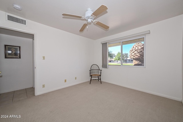 empty room featuring light carpet and ceiling fan