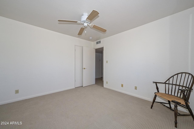 unfurnished room with ceiling fan and light colored carpet