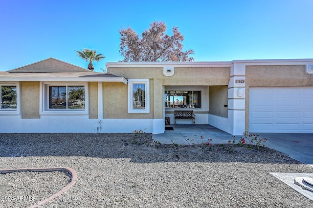 ranch-style home featuring a garage