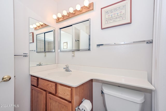 bathroom featuring toilet and vanity