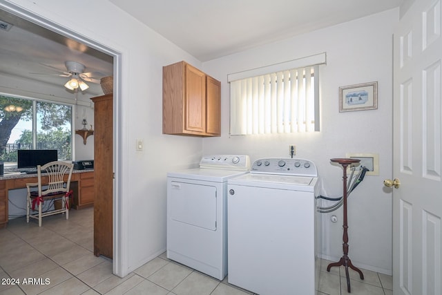 laundry area with washer and clothes dryer, cabinets, ceiling fan, and light tile patterned flooring