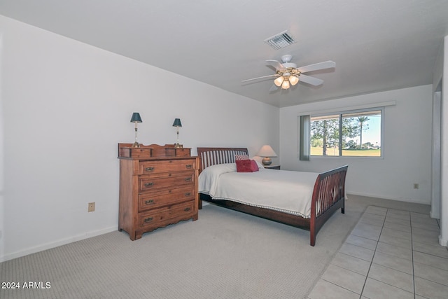 tiled bedroom featuring ceiling fan