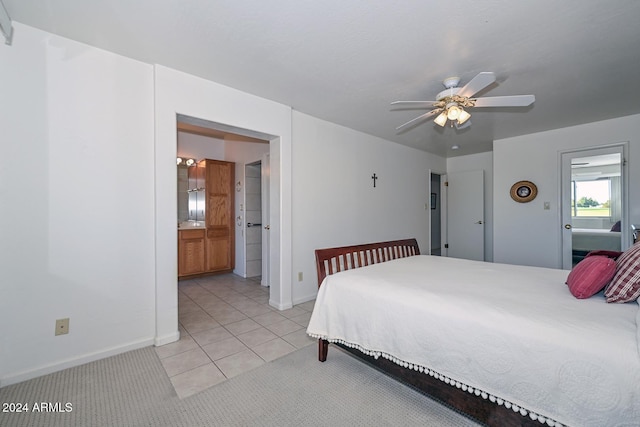 bedroom featuring ensuite bath, ceiling fan, and light colored carpet