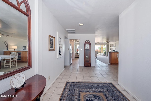 hall with light tile patterned floors