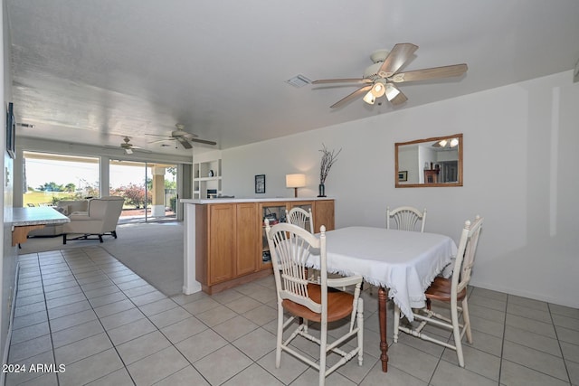 tiled dining room featuring ceiling fan