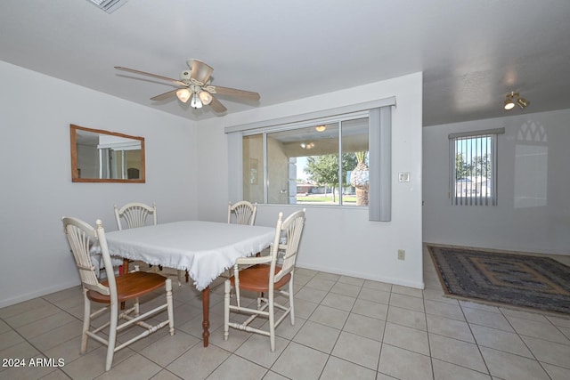 dining space with a healthy amount of sunlight, ceiling fan, and light tile patterned floors