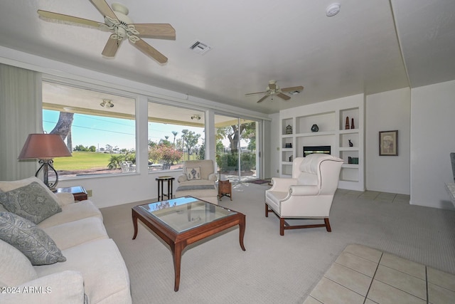 carpeted living room with ceiling fan