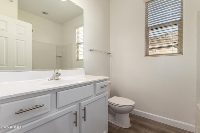 bathroom featuring hardwood / wood-style flooring, vanity, and toilet