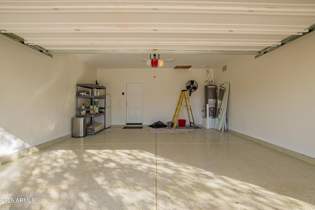 garage featuring a garage door opener, gas water heater, and white fridge