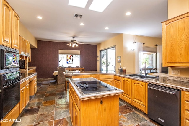 6334 E Albany St, Mesa, AZ 85205 - kitchen with black appliances, a sink, stone tile flooring, a peninsula, and recessed lighting