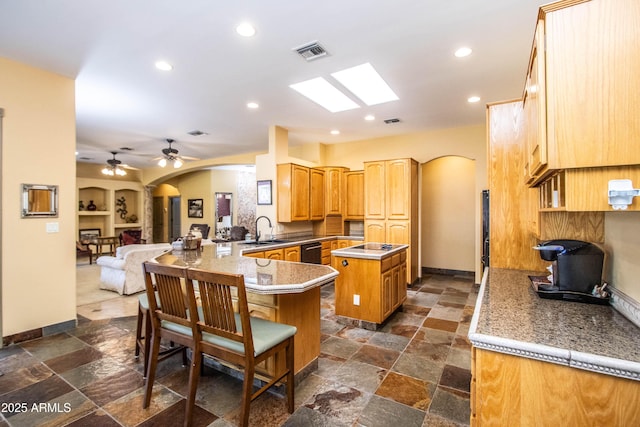 6334 E Albany St, Mesa, AZ 85205 - kitchen featuring arched walkways, a peninsula, a sink, a center island, and black dishwasher