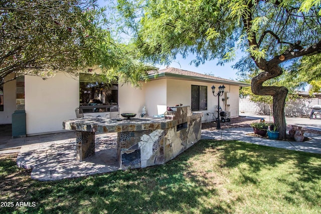 6334 E Albany St, Mesa, AZ 85205 - back of house with stucco siding and a patio