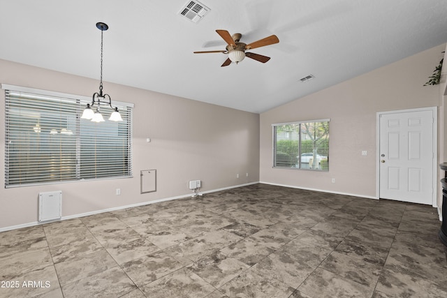 interior space with lofted ceiling, visible vents, baseboards, and ceiling fan with notable chandelier