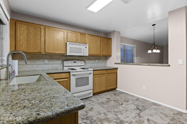 kitchen featuring a sink, baseboards, decorative backsplash, and white appliances