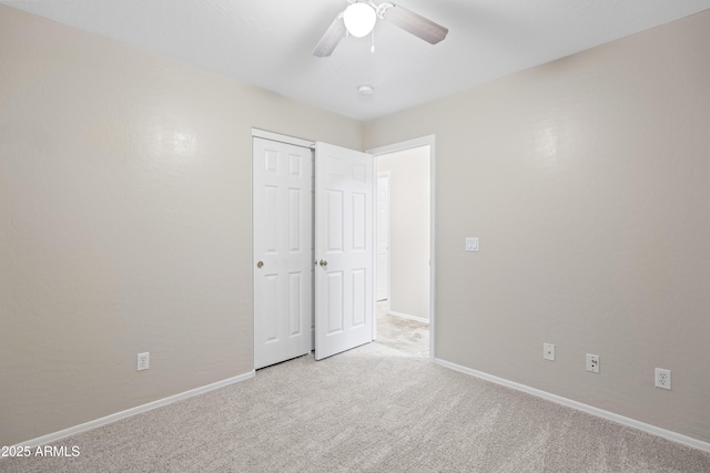 unfurnished bedroom featuring baseboards, a ceiling fan, carpet floors, and a closet